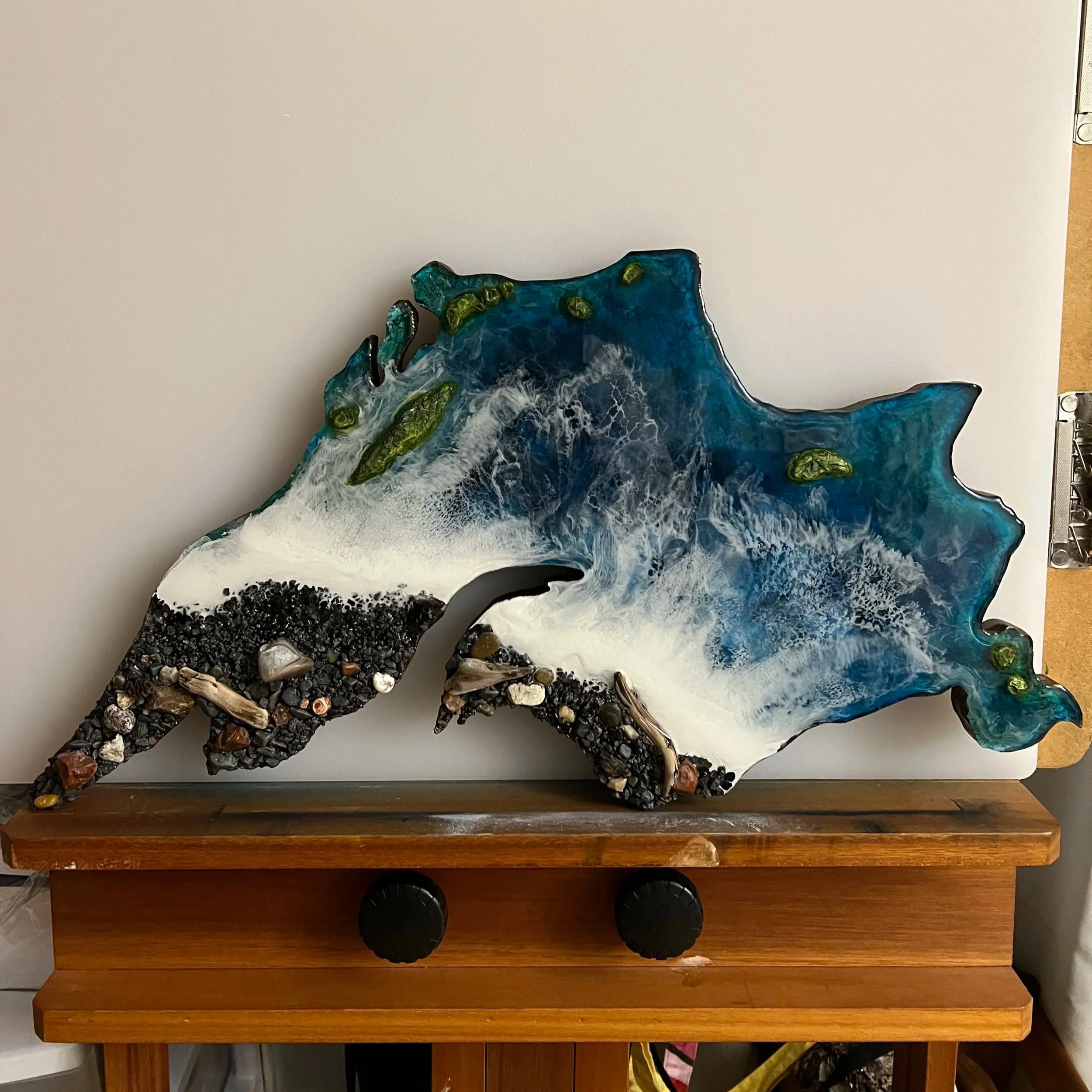 A resin artwork created in the shape of Lake Superior, with real sand, drift and agates found on the black beaches of the Great Lake 
