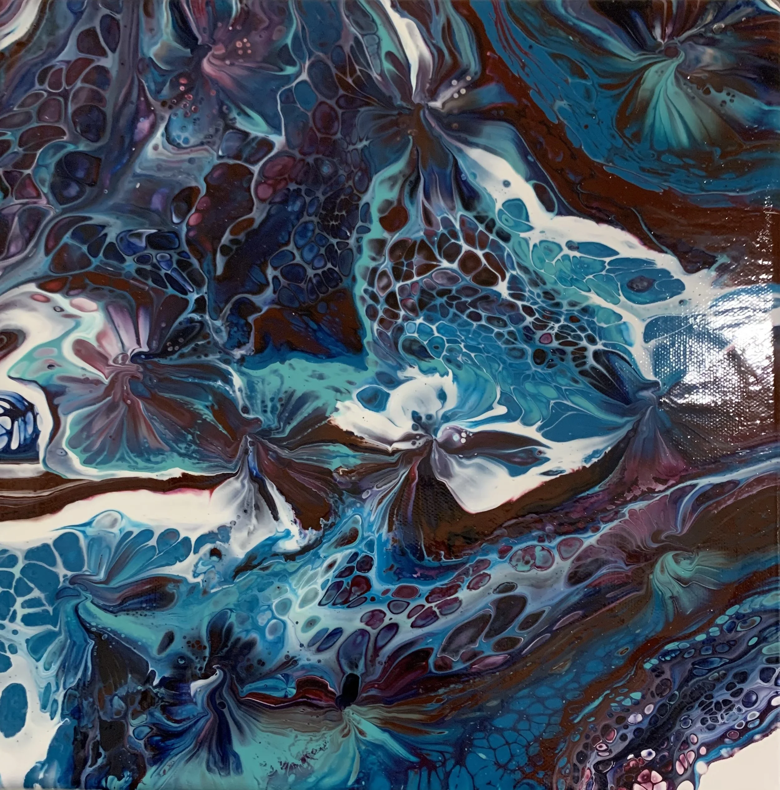 Abstract fluid painting with swirling patterns in shades of blue, white, purple, and brown, resembling ocean waves or coral formations.