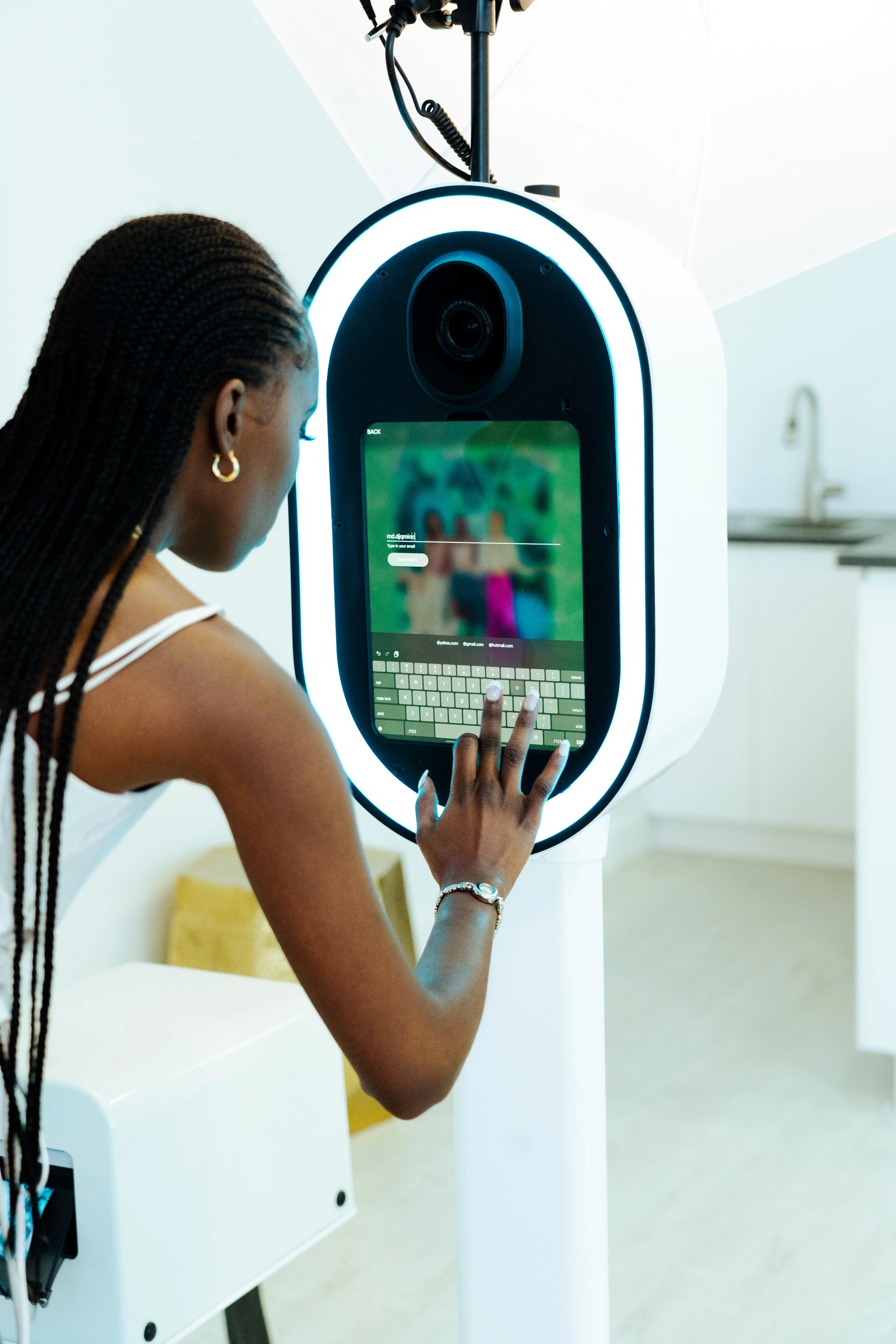 A wedding guest using a photo booth to take a photo.