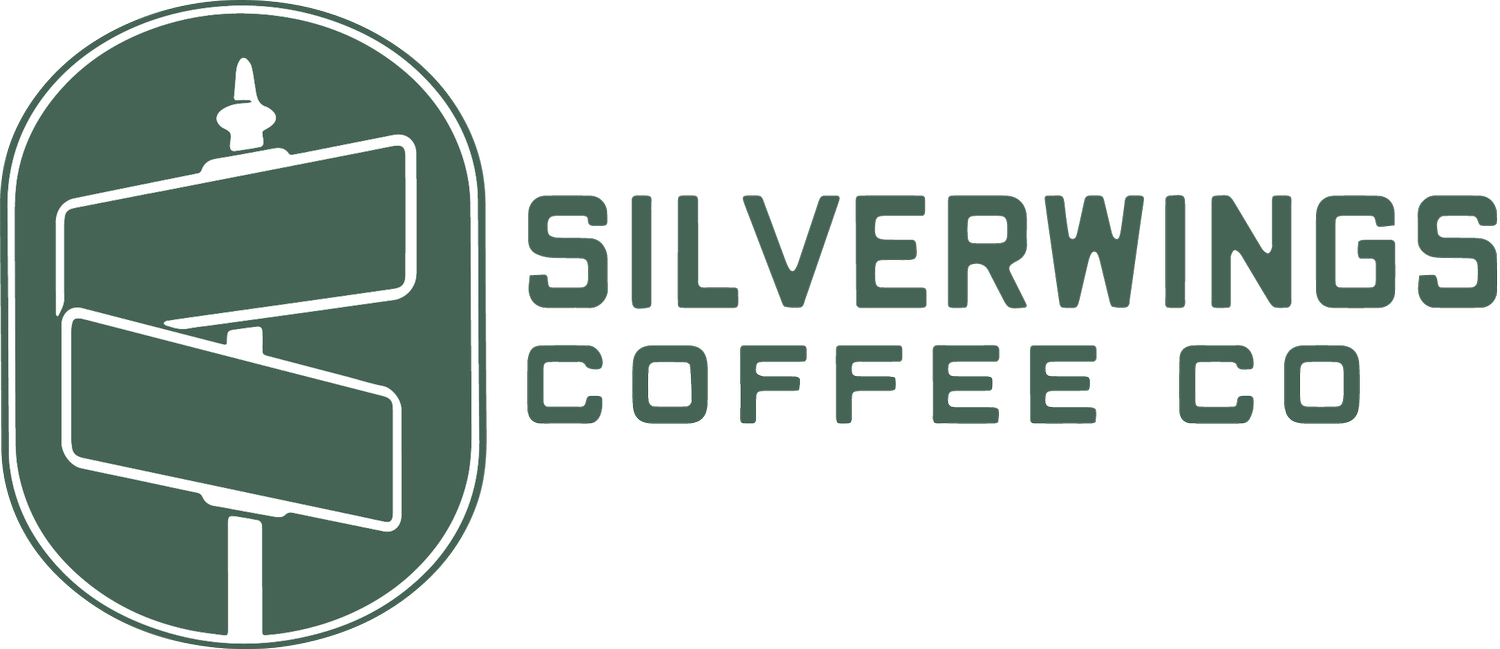 Logo of Silverwings Coffee Co. featuring a signpost with two arrows and the text 'SILVERWINGS COFFEE CO' next to it.