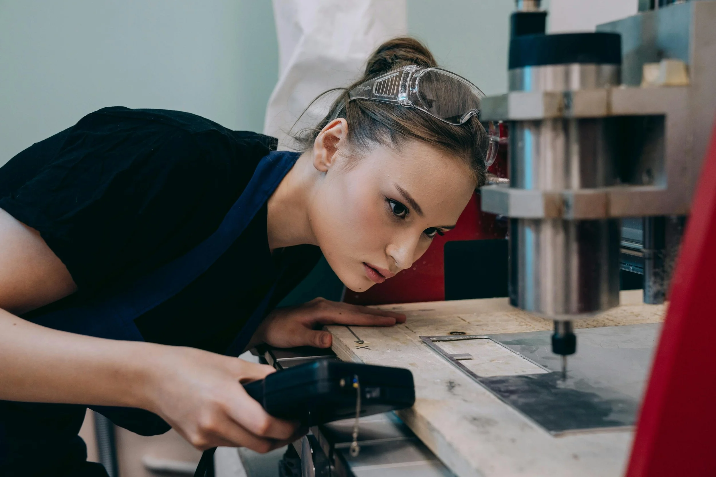 Student working with tools in a manufacturing workshop