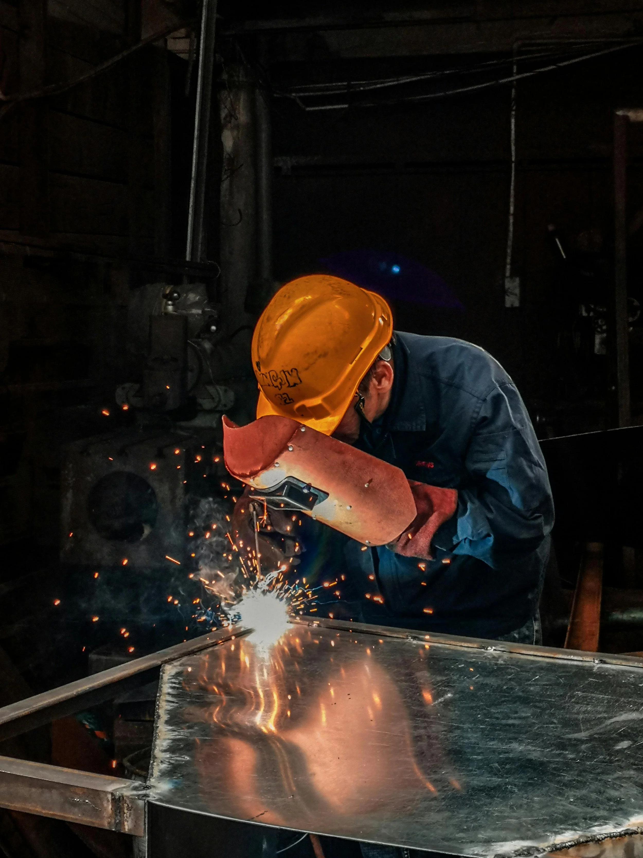Welder working as sparks fly