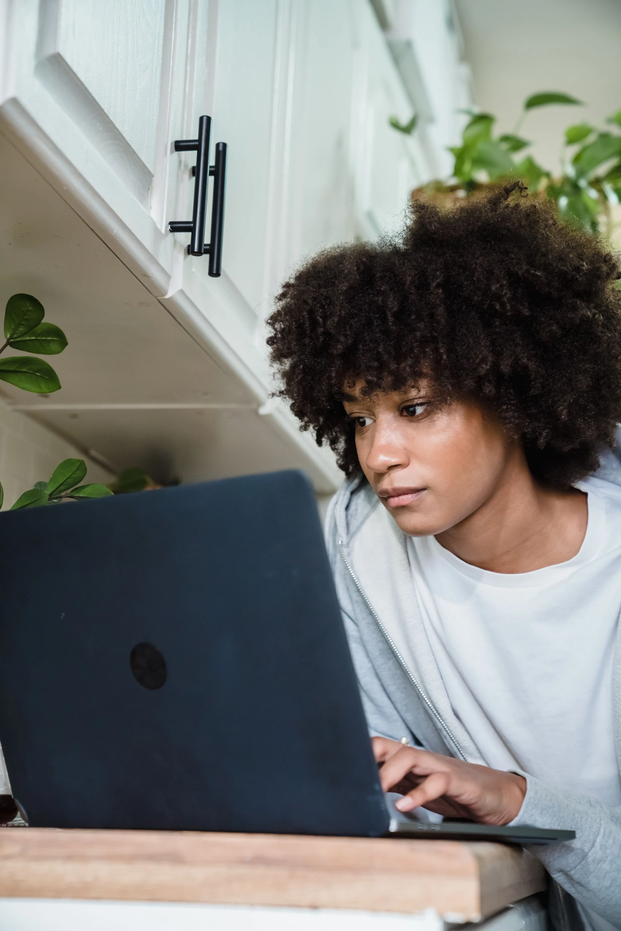 Student focused on a laptop at a desk