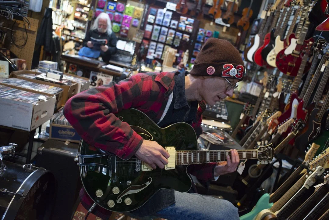 Dan Shrapo plays guitar at Blue Eagle Music Shop on Court Street in Athens, Ohio on Friday, March 24th, 2023. Dan live in Columbus Ohia He says, "I haven't been to Athens for 25, 30 years" Now, he would like to attend Ohio University for a master's p