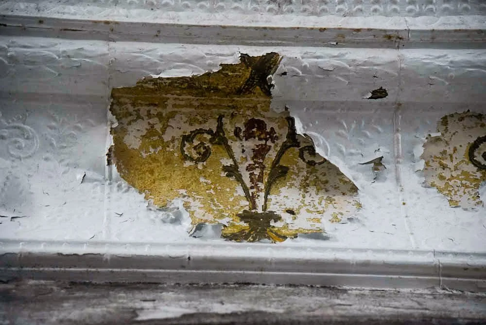 Inside the current Mount Zion Baptist Church. The wallpaper is corroded and peels off revealing the original wallpaper design. | Patricia Porter