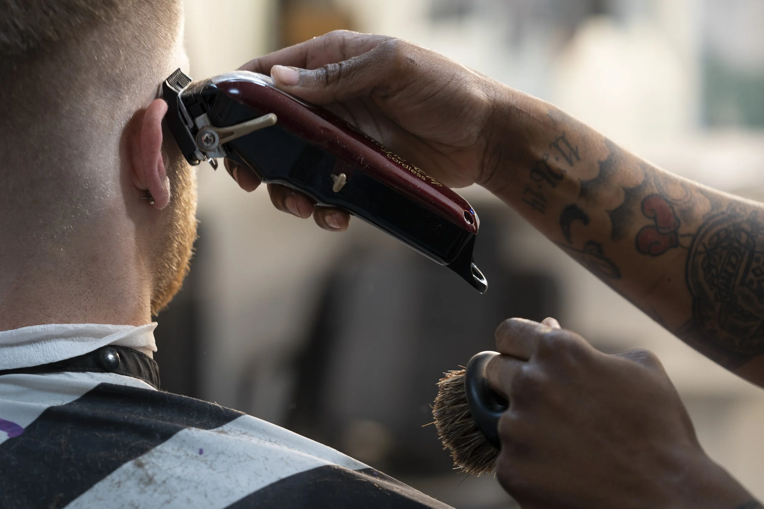 Barber Smitty Smith at Bam & Bros. Barbershop shaves the side of Blake Hydes head as he talks about the upcoming Fest season at Ohio University on March 24, 2023. | Megan VanVlack