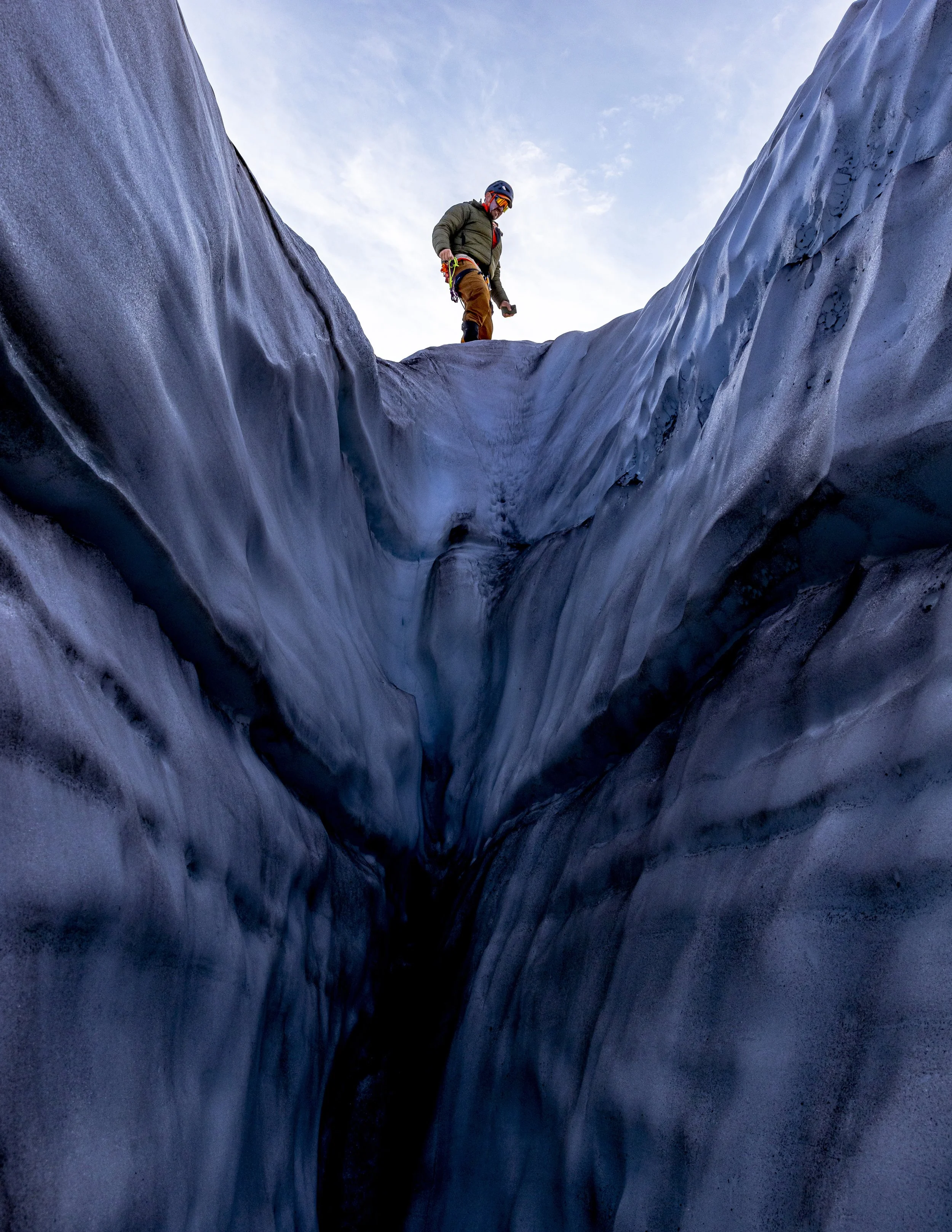 Derick Prins, of Novi, Mich, walks beside the edge of a crevasse on the Easton Glacier on Mt. Baker in Wash., on August 25, 2023. The American Alpine Institute has been educating aspiring alpinists for more than 45 years. They continue the tradition