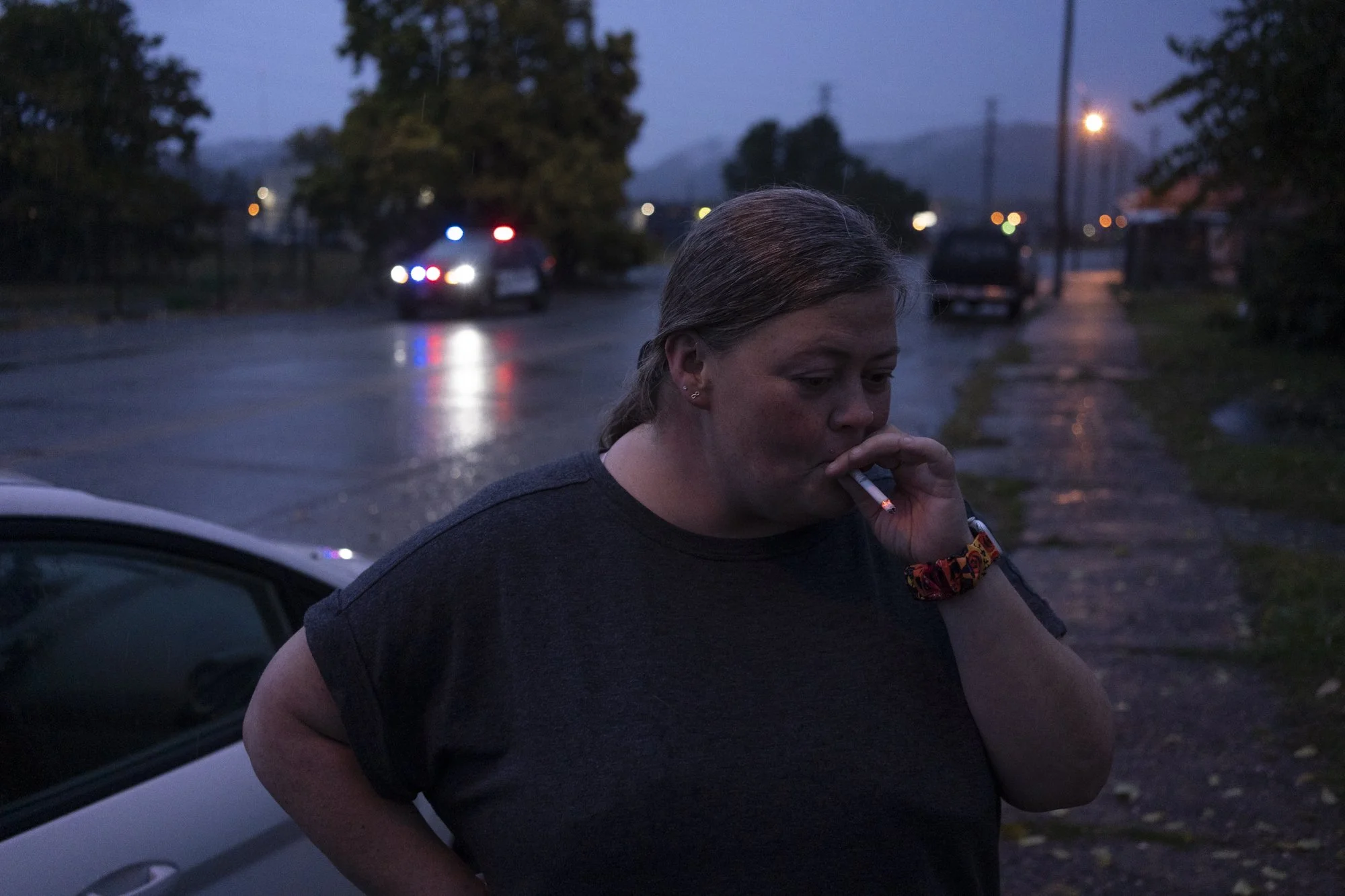 Abby Spears, of New Boston, the Coordinator of Injury Prevention at the Portsmouth City Health Dept., smokes a cigarette after stepping out from the syringe exchange to see why the police were curbside. According to Spears, some of the people who vis