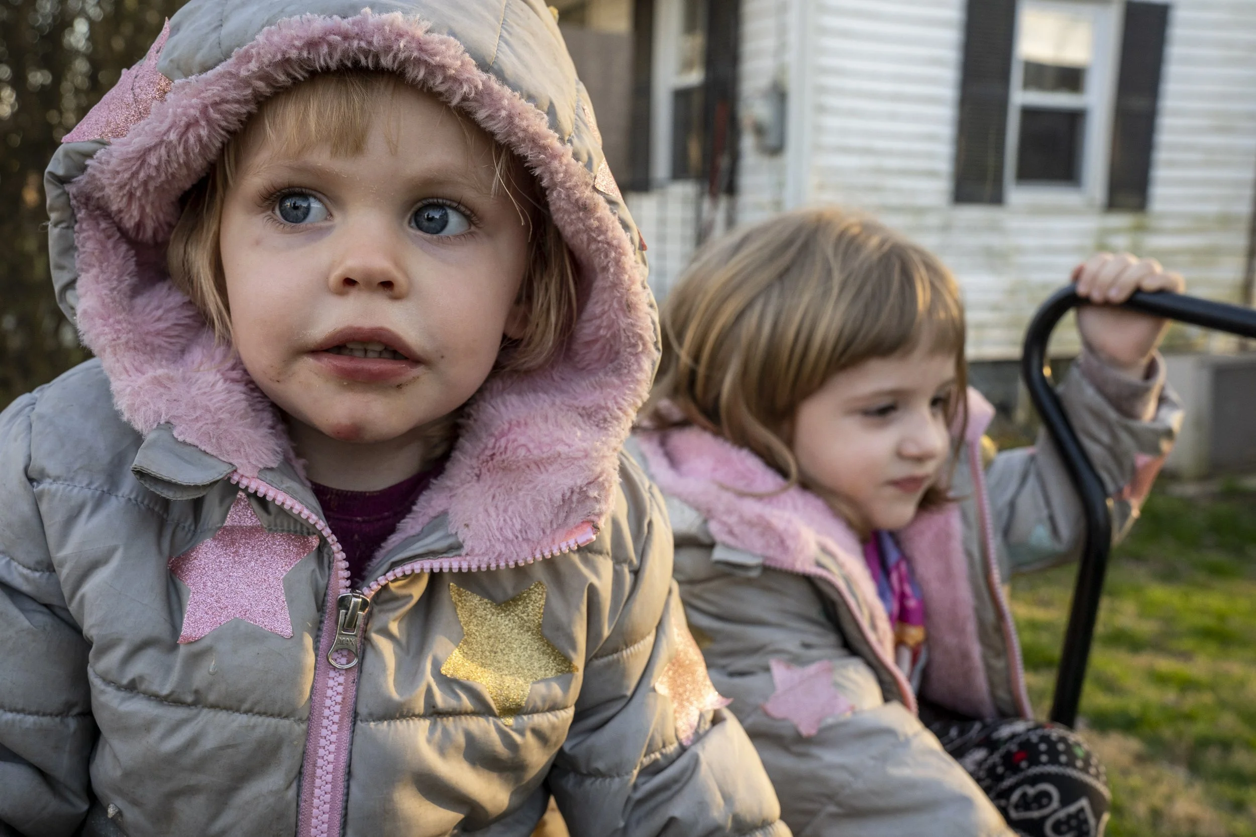 Cassy and Mac Stump play in a wheelbarrow in the front yard of their home. They live with their parents and aunt in Shade, Ohio, in Lodi Township. Since the closing of the Shade School in 2005, kids in Shade have fewer opportunities to meet other chi
