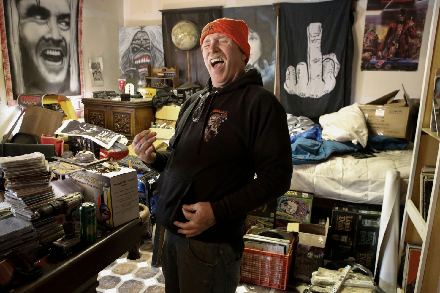 Brewce Martin plays air guitar to "Nothing Else Matters" by Metallica at his home at Skatopia in Rutland, Ohio, March 23, 2024.