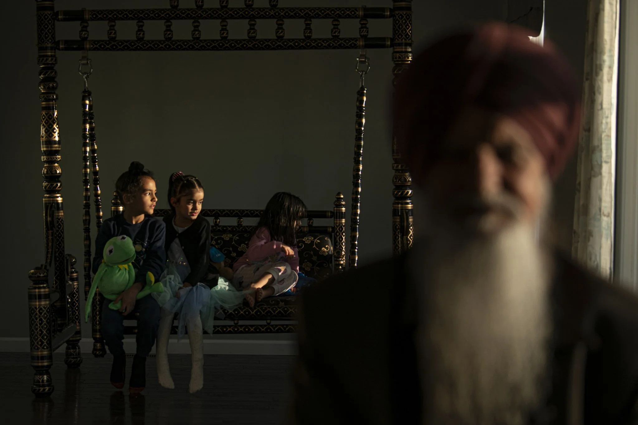 Agam Singh, 7, plays with Kermit the Frog alongside his cousins while his grandfather rests on the couch at their residence in Twinsburg, Ohio. Agam's father moved to the United States a few years ago for a better lifestyle and raised him here. His f