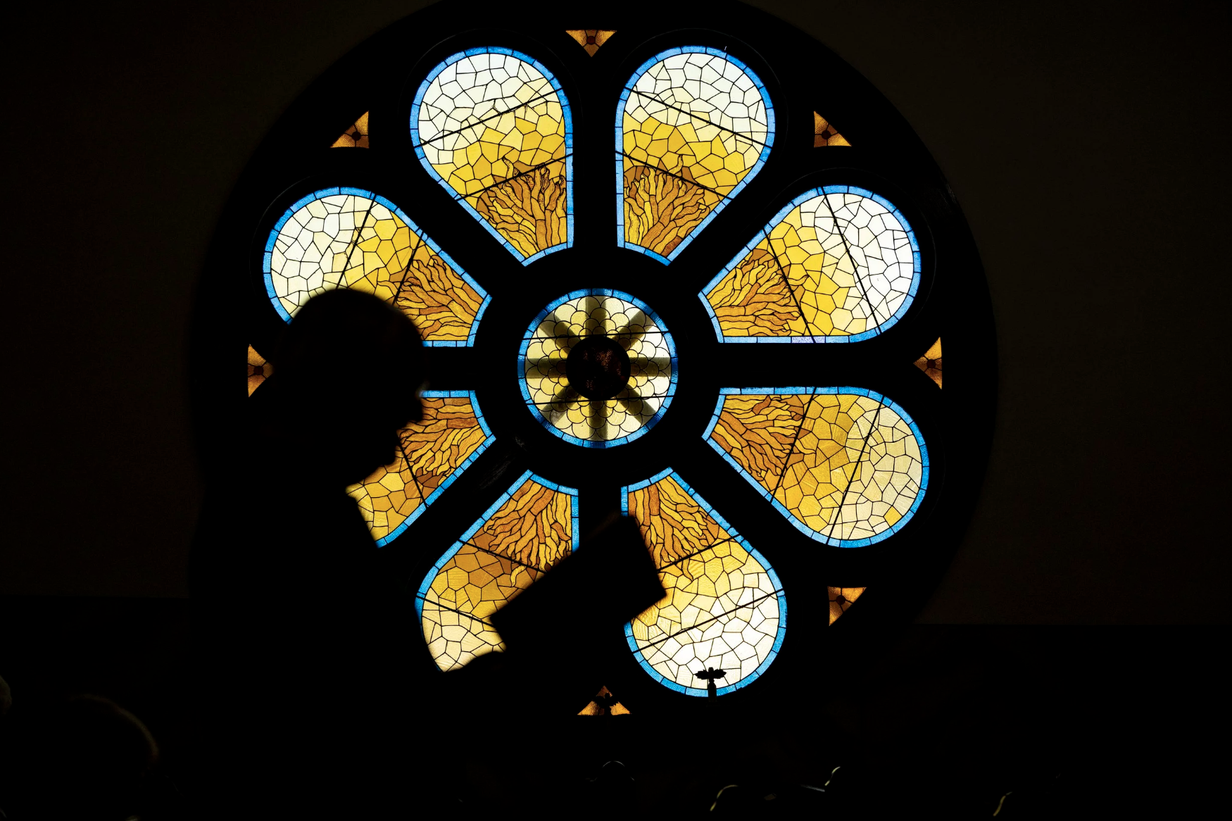 Ken Gabriel reads his bible as Pastor Rick gives the reading during the Sunday service at Stewart United Methodists Church in Stewart, Ohio. The stained glass in the church came from a church that was about to be torn down in Washington D.C. and was