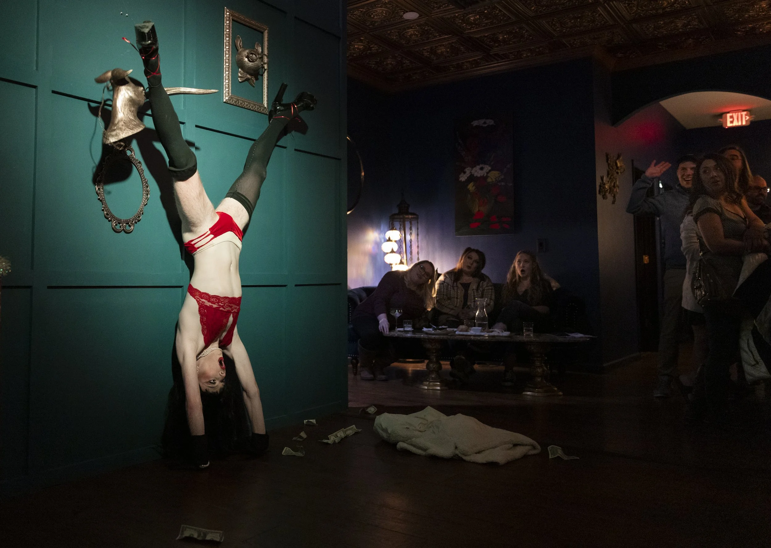 Drag performer. Evelyn Everything knocks a decorative ornament off of the wall during her performance at Kazma's Holiday Spectacular at Athens Uncorked on December 3, 2022. | Charlie Nick