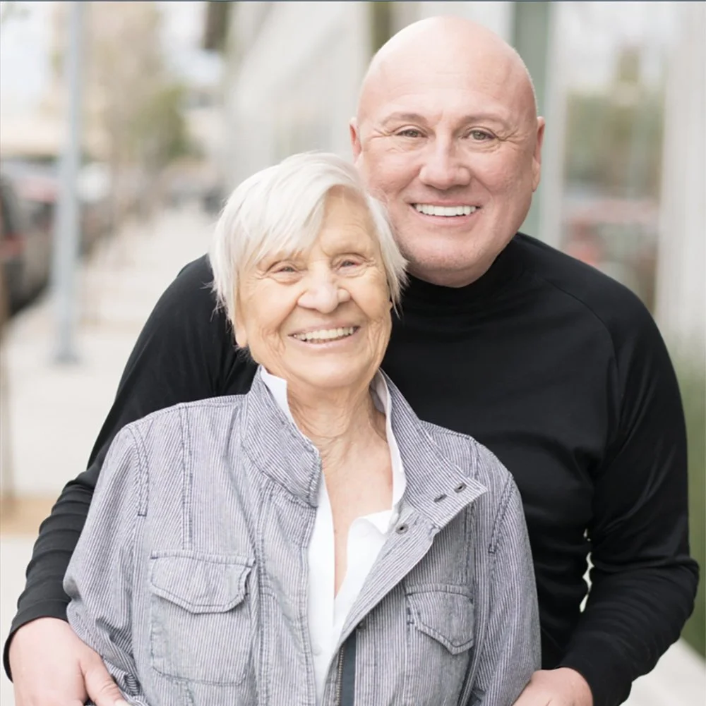 A mother & son outside smiling.