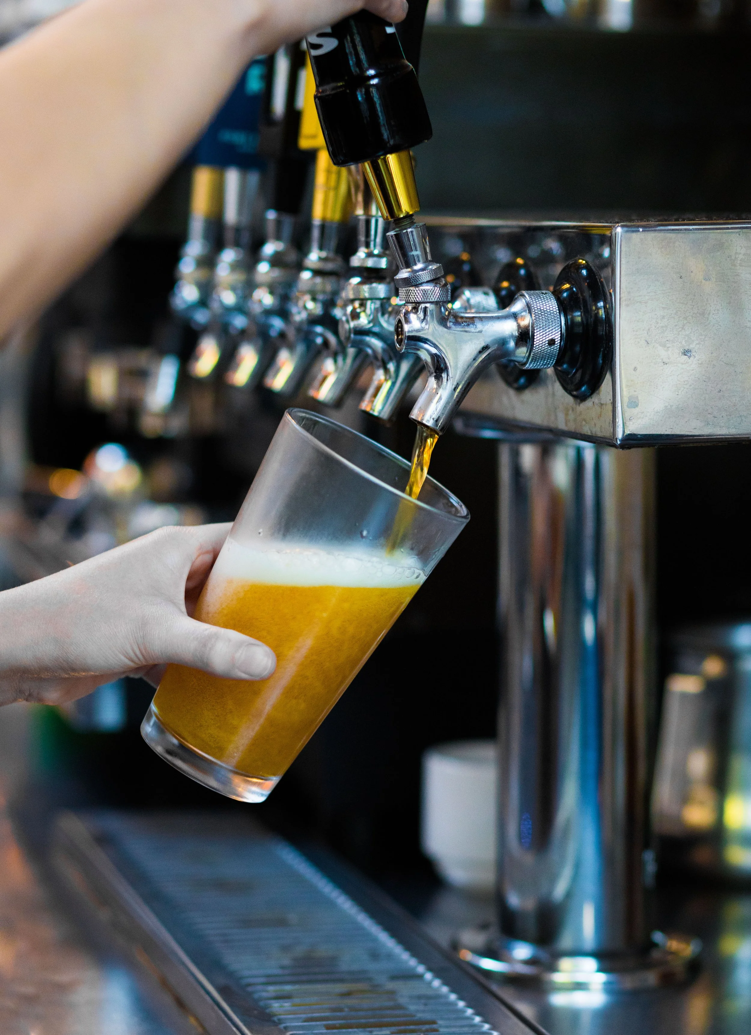 Person pouring beer from a tap into a clear glass at Papito Hayes in Hayes Valley, San Francisco