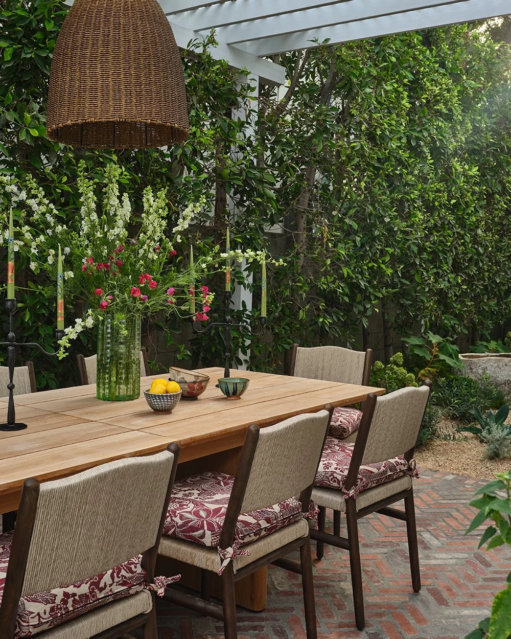 Outdoor dining room with pergola in a Hollywood Bungalow home designed by Raychel Wade Design
