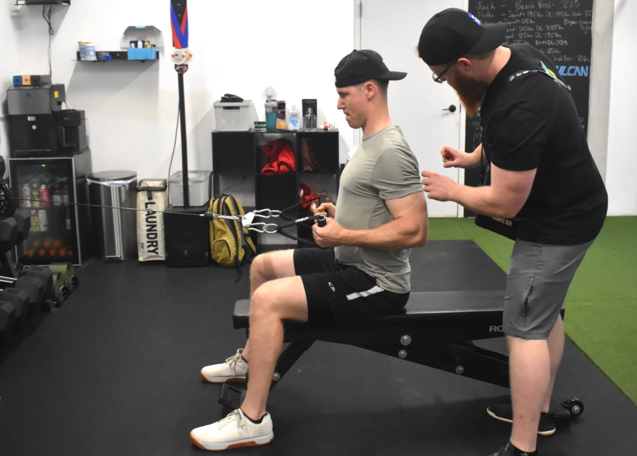 Coach Nathan is helping a client understand a cable row cue they have been working on over the past few sessions.