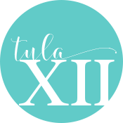 Teal circle with white text that reads 'tula XII' in cursive and roman fonts.