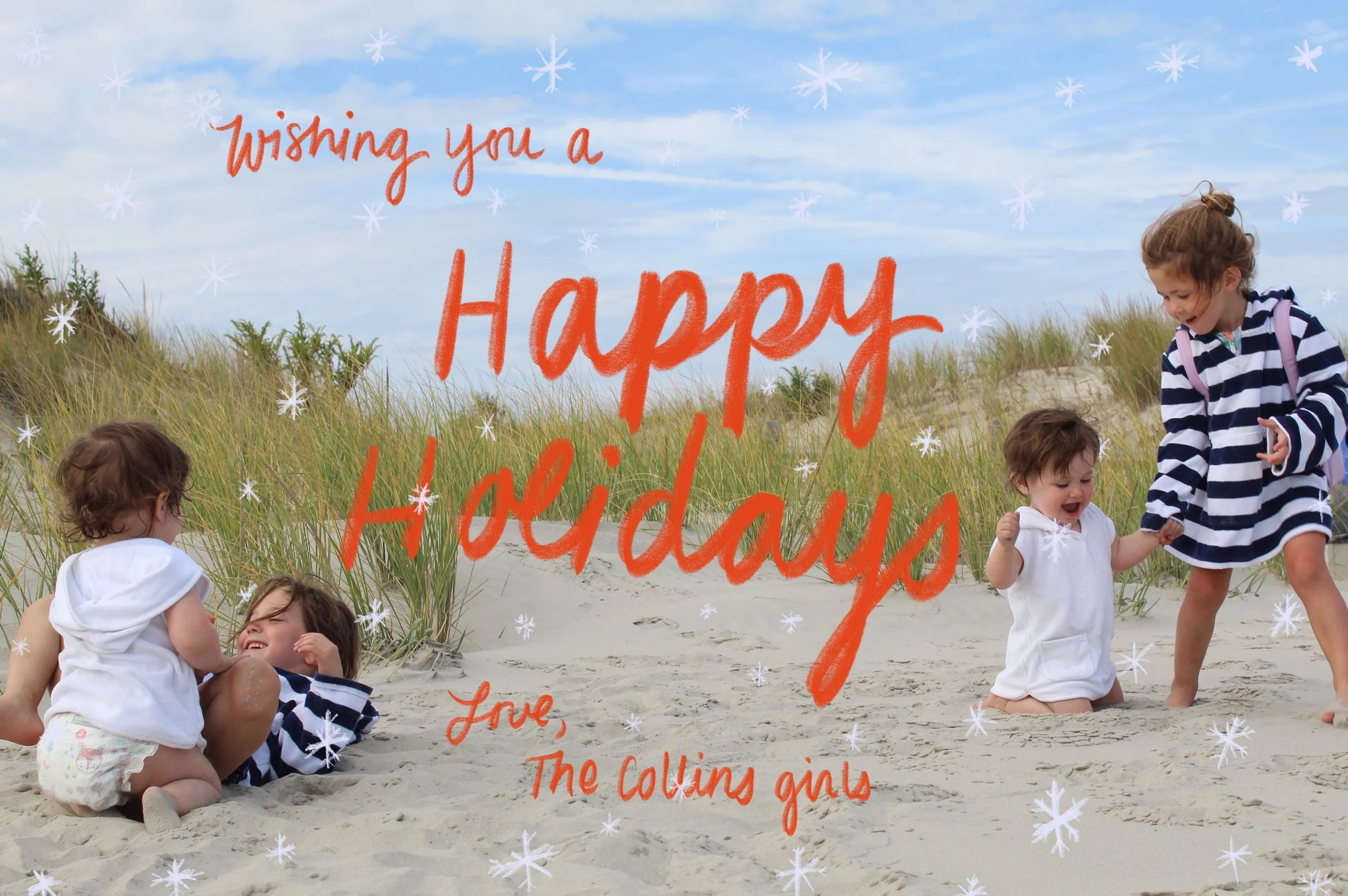 Children playing on a sandy beach with sand dunes and grass under a blue sky with some clouds. Text overlay says 'Wishing you a Happy Holiday Love, The Collins girls' in red script and block fonts, with snowflake decorations scattered across the imag