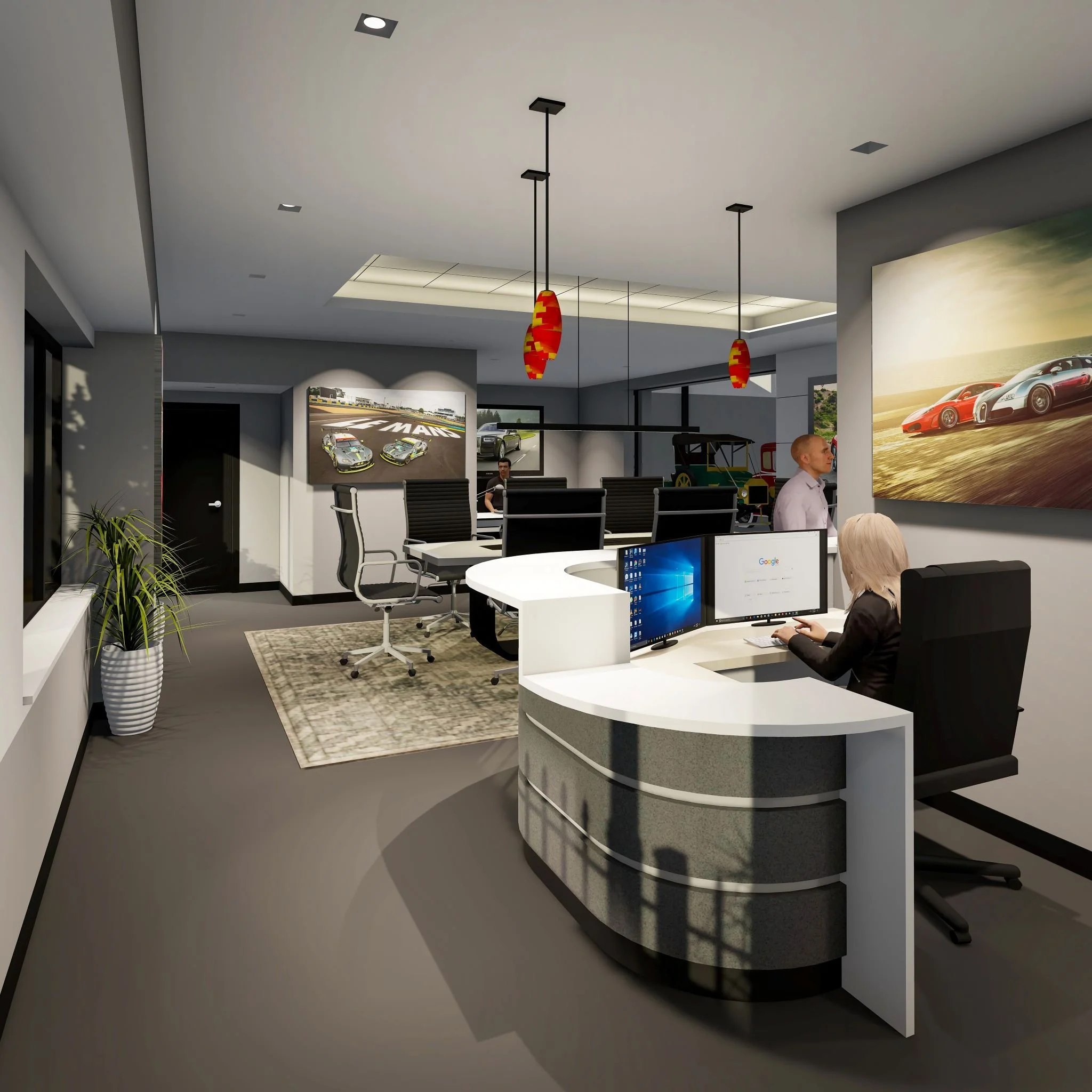 Modern office with a reception desk, multiple workstations, and large wall-mounted car race and sports car photographs. People are working at their desks, and a potted plant is visible near a window.