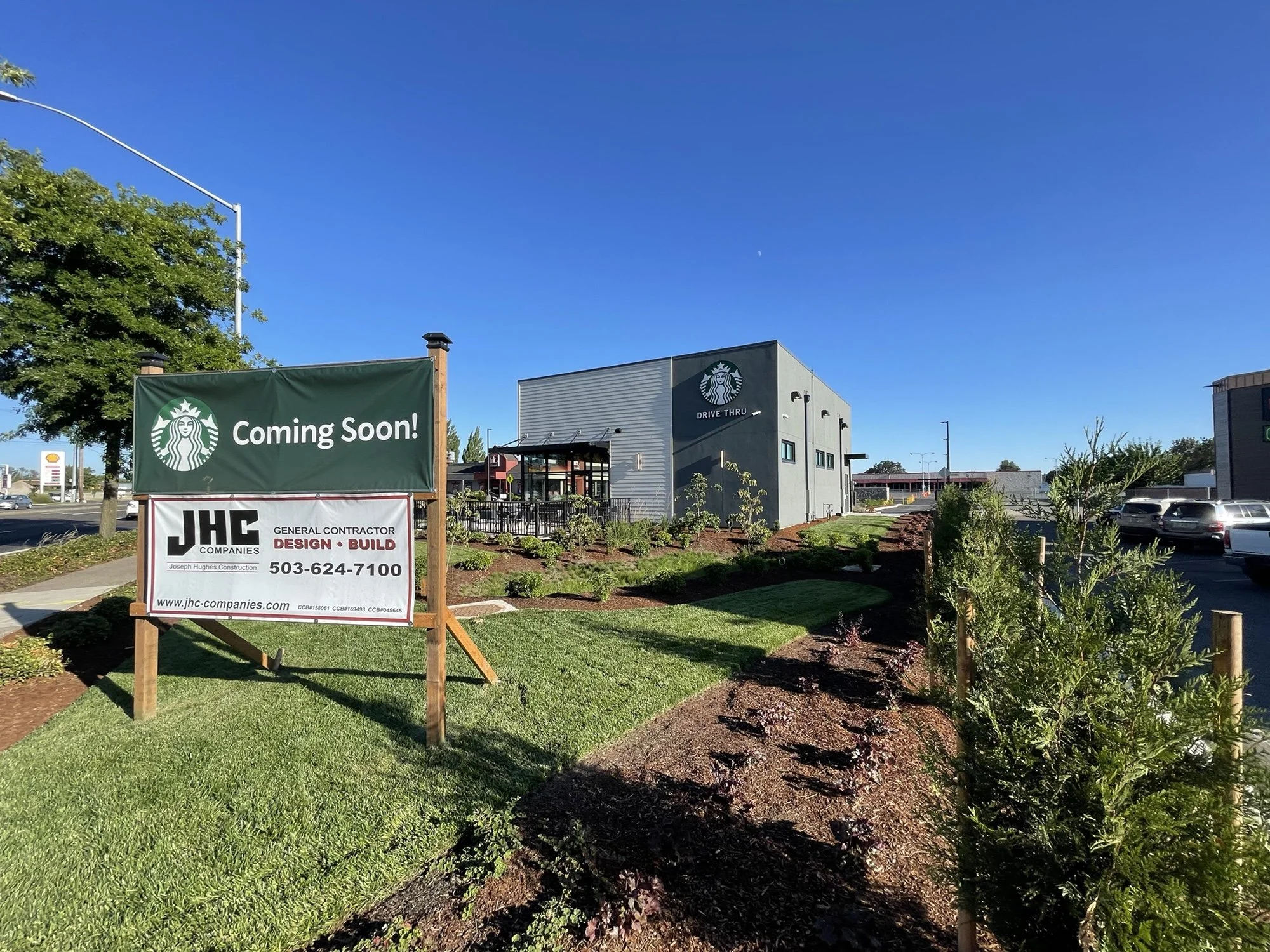 SBUX and JHC Sign with Building in background.jpeg