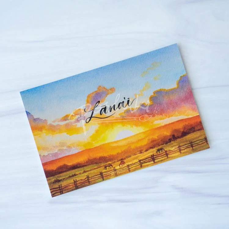 A watercolor landscape postcard featuring a painting of a sunset at Koele, with the word "Lānaʻi" on the top.