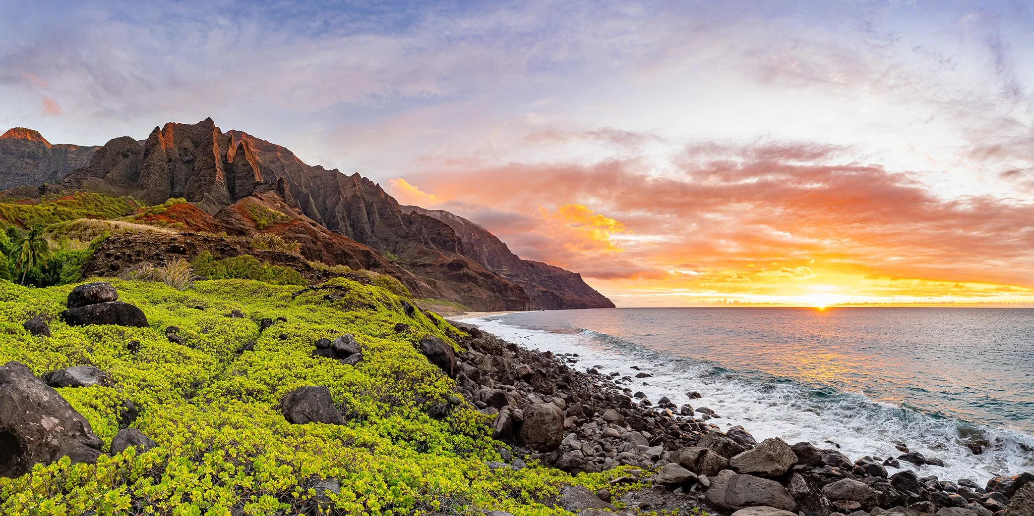 A panoramic fine art photograph of a spectacular sunset from Kalalau Valley on the Nā Pali Coast of Kauai, Hawaii
