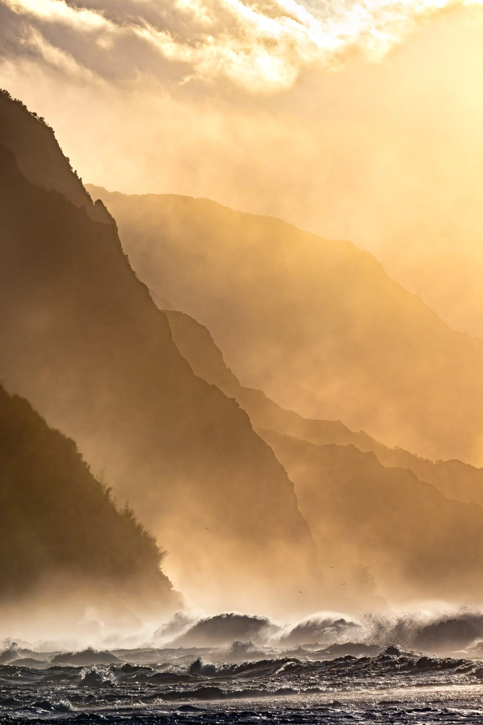 Golden sunset illuminating the dramatic sea cliffs of the Nā Pali Coast, Kauaʻi Hawaii landscape photography