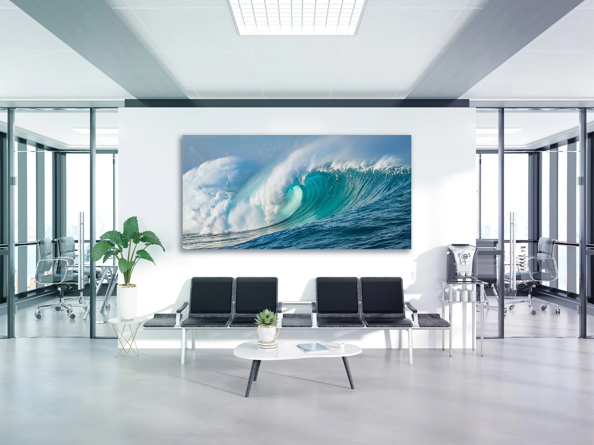 Modern office waiting area with a large wall-mounted picture of ocean waves, black chairs, potted plants, a coffee table with a magazine, and office furniture visible through glass walls.