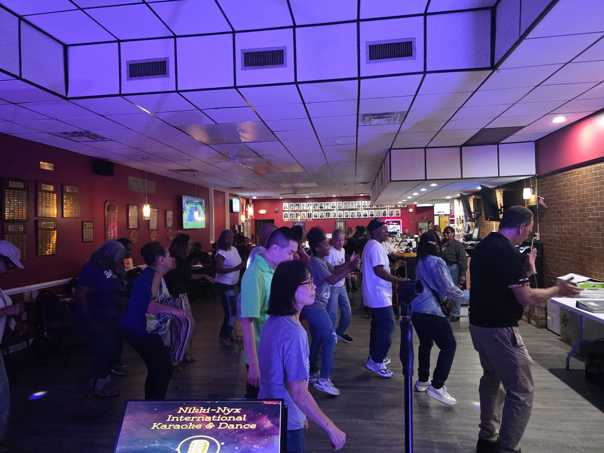 Guests dancing and singing together at Nikki NYX International Karaoke & Dance, capturing the joyful, multicultural energy of a community-centered karaoke night in the DMV.