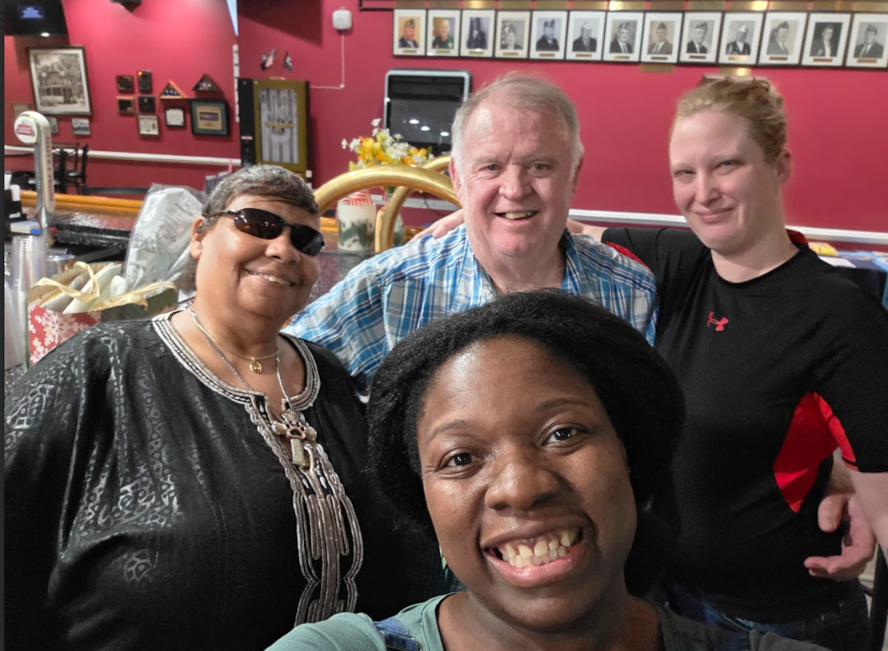 Community members smiling together at a Nikki NYX International Karaoke & Dance event, highlighting the welcoming, friendly atmosphere that brings people together through music.