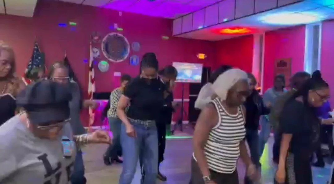 ladies on the dance floor dancing in sync.