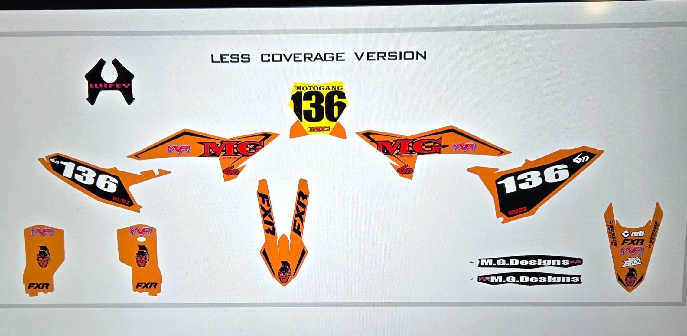 Graphics of a motocross bike decal set labeled Less Coverage Version, featuring orange, black, and white colors with number 136, and various brand logos including MVR, FXR, and M.G. Designs.