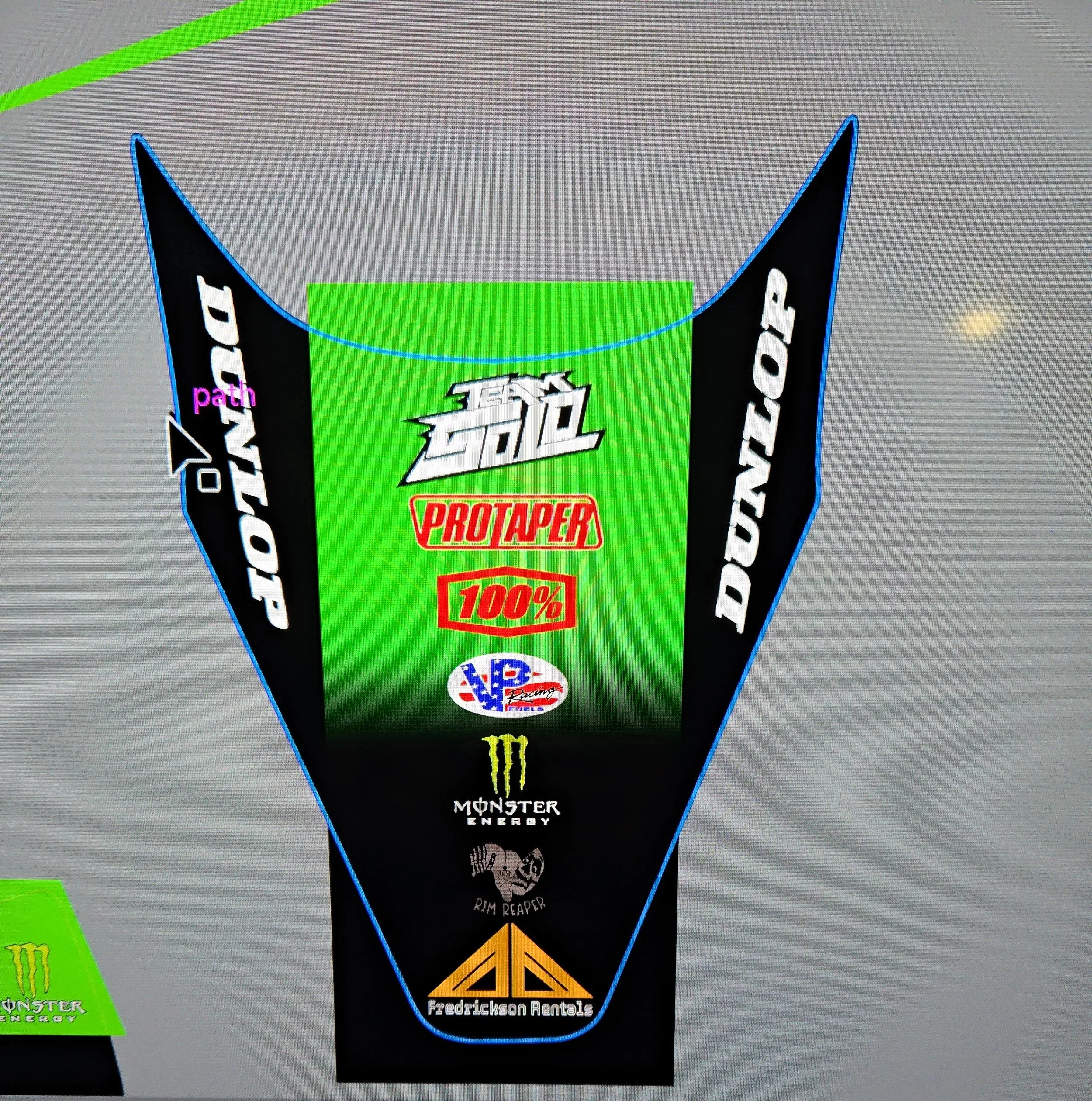 A racing number plate with various sponsor logos, including Monster Energy, ProTaper, and Fredrickson Rentals, with a green background and black sides.