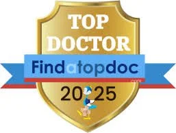 Gold shield emblem with text "Top Doctor" at the top, a blue ribbon with "Find a top doc" across the center, and "2025" at the bottom. A small icon of a doctor with a stethoscope is underneath.