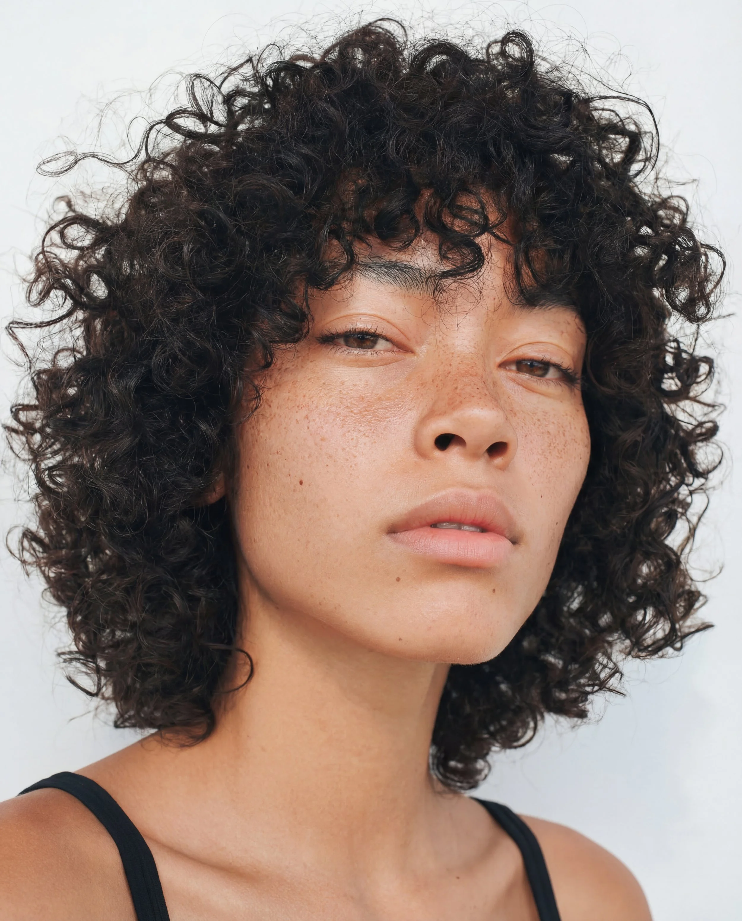 AVA. Quiet confidence. Soft features, natural curls, calm strength. Works well for editorial, fashion stories, beauty with character.