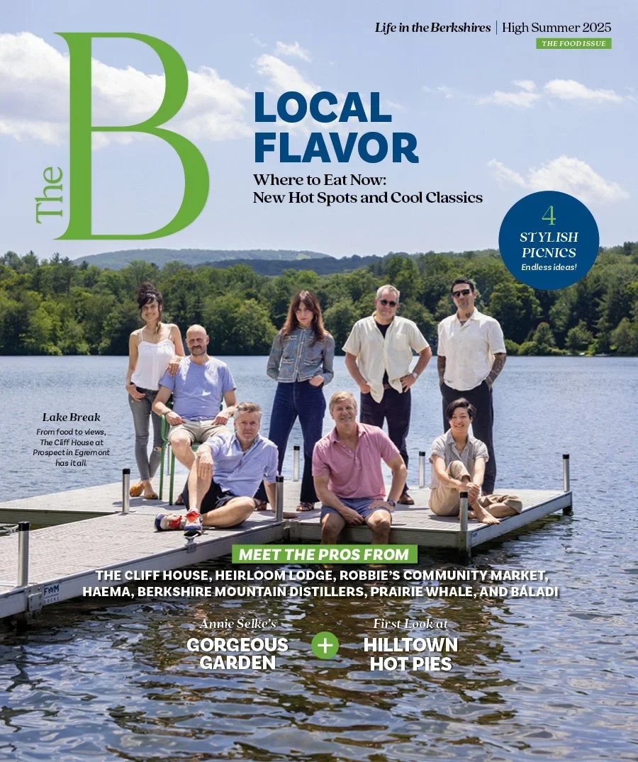 Magazine cover titled "The Berkshires High Summer 2025 - The Food Issue" with a family of nine people on a dock by the lake, surrounded by green trees and blue sky.