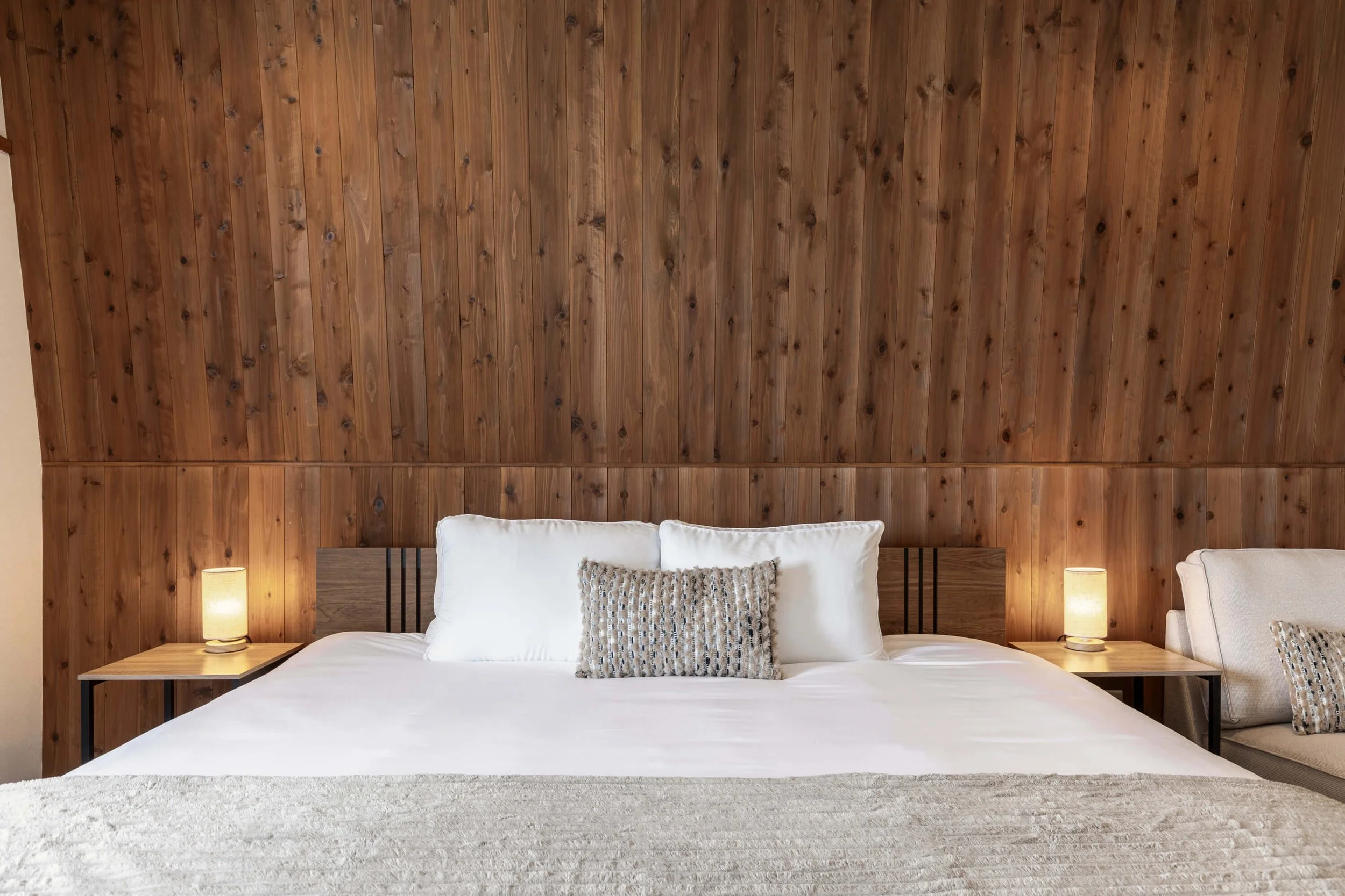 The Residence Myoko King Room with red cedar walls and premium bedding.
