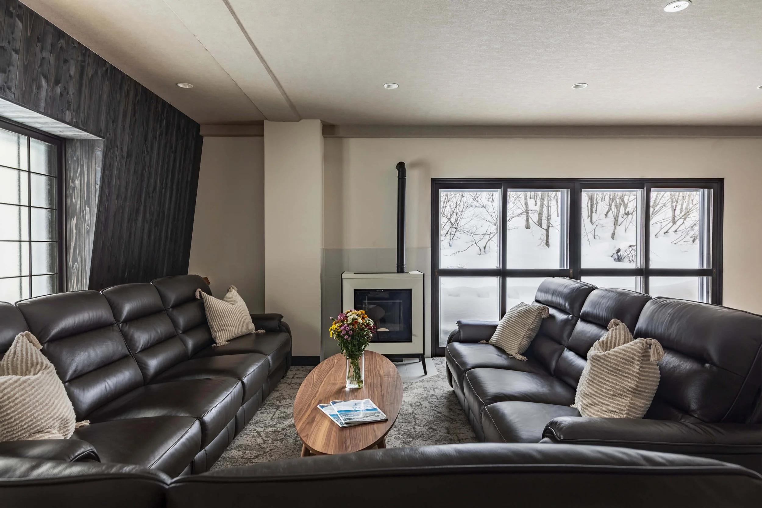 Cozy living room with fireplace at The Residence Myoko luxury ski lodge.