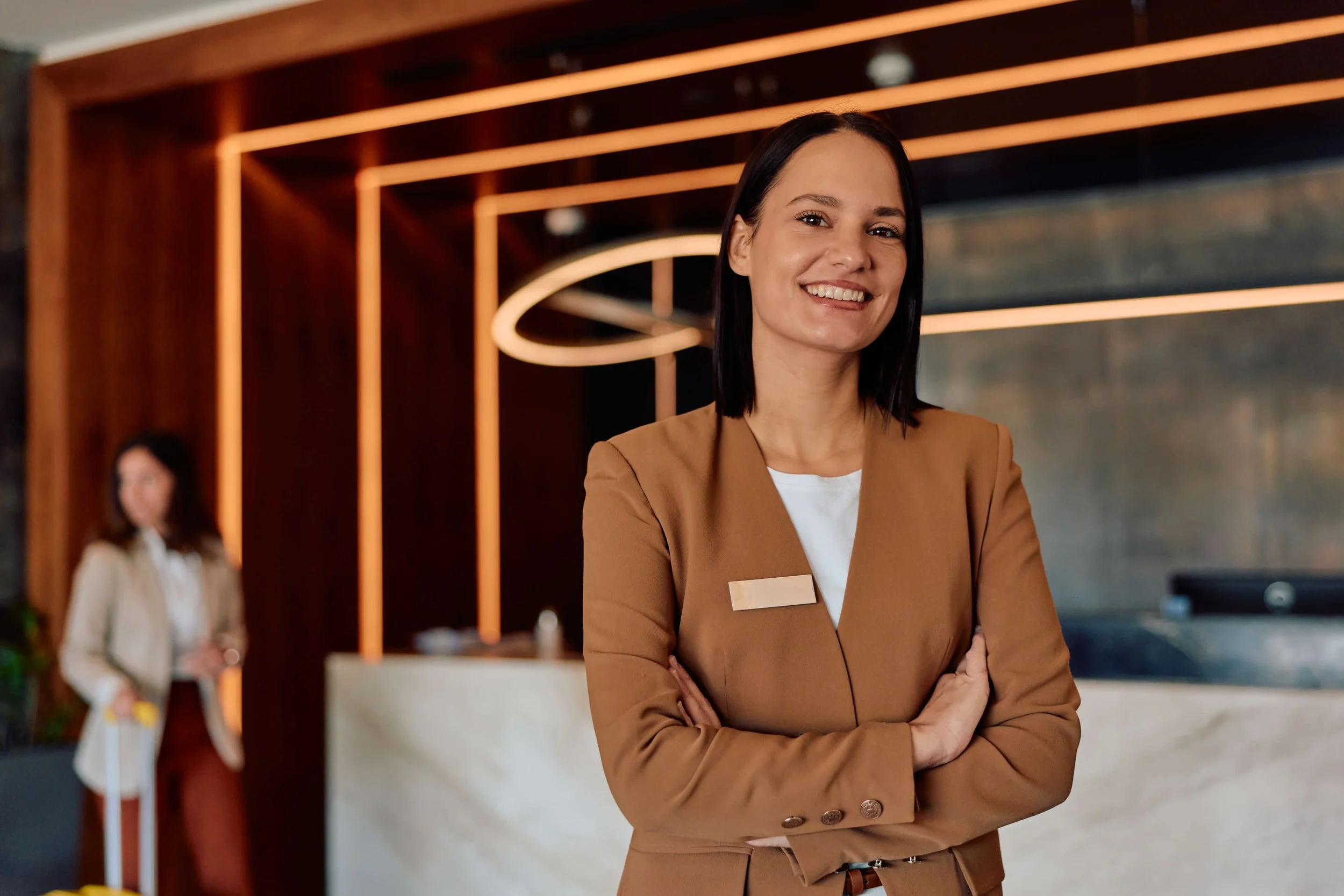 Woman standing in front of hotel reception desk