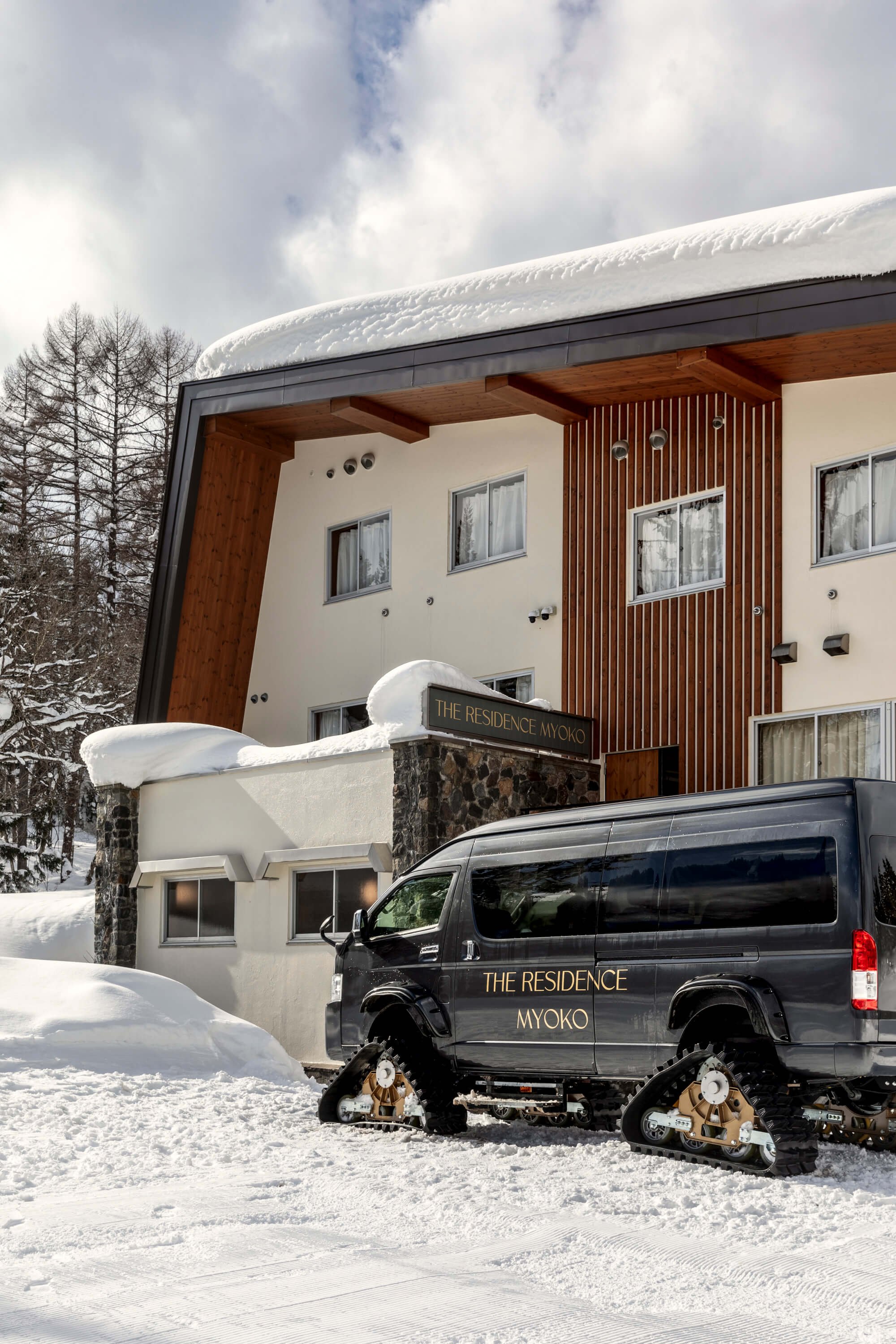 The Residence Myoko lodge and the private shuttle bus parked out front showing ski in ski out access