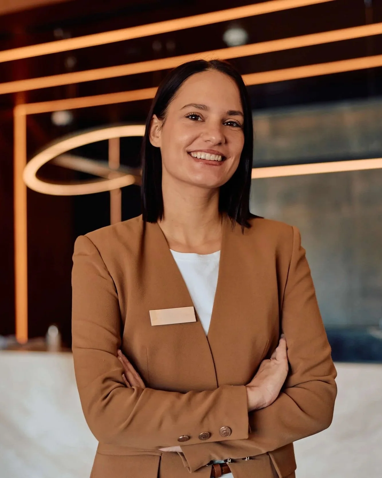 Female hotel manager standing in front of reception desk
