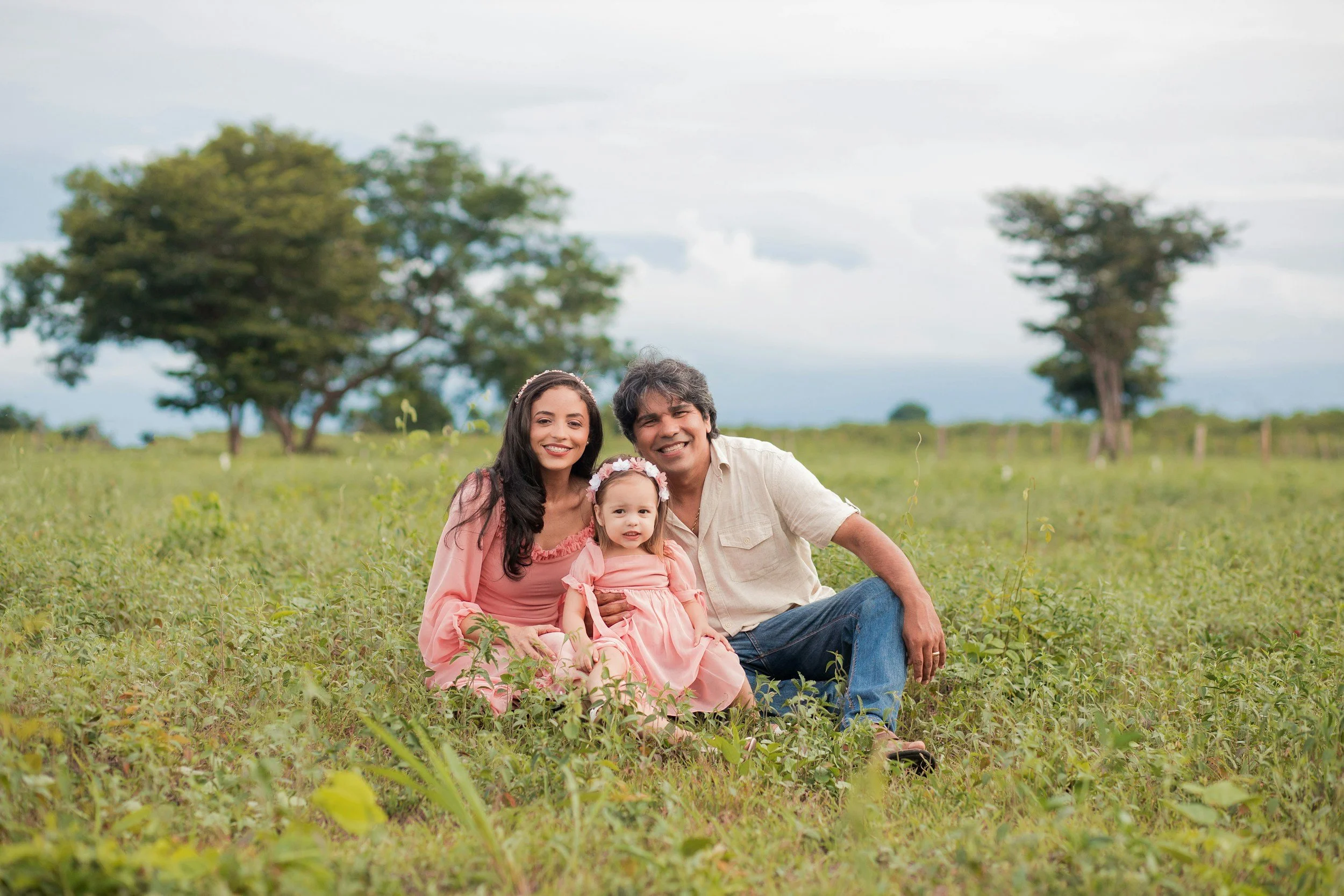“Children’s family portrait in Louisville, KY featuring three siblings sitting together in a flower field during a lifestyle photography session by LuxLens Portrait Studio.”