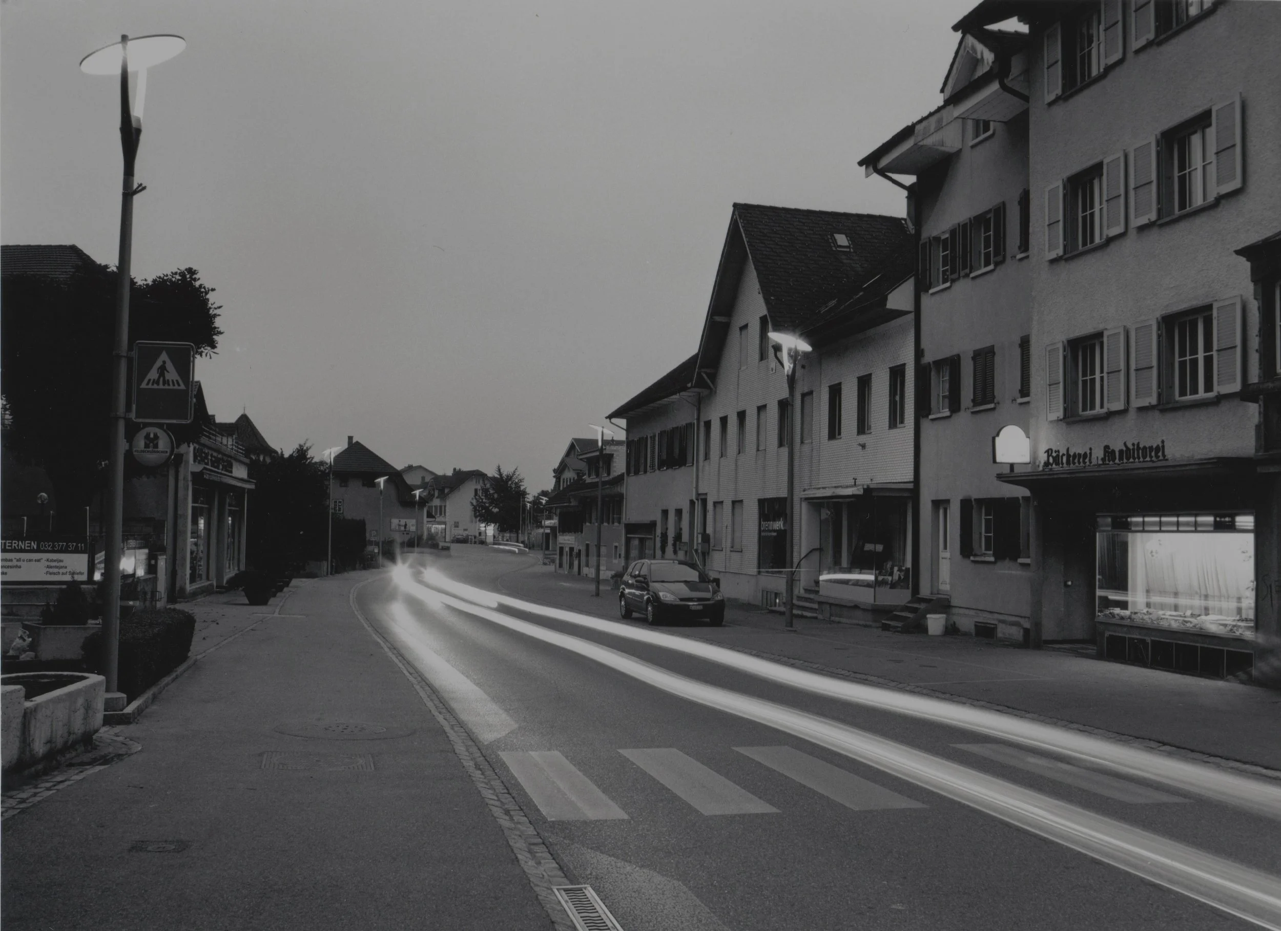 Main Street with Retail Stores at Dusk