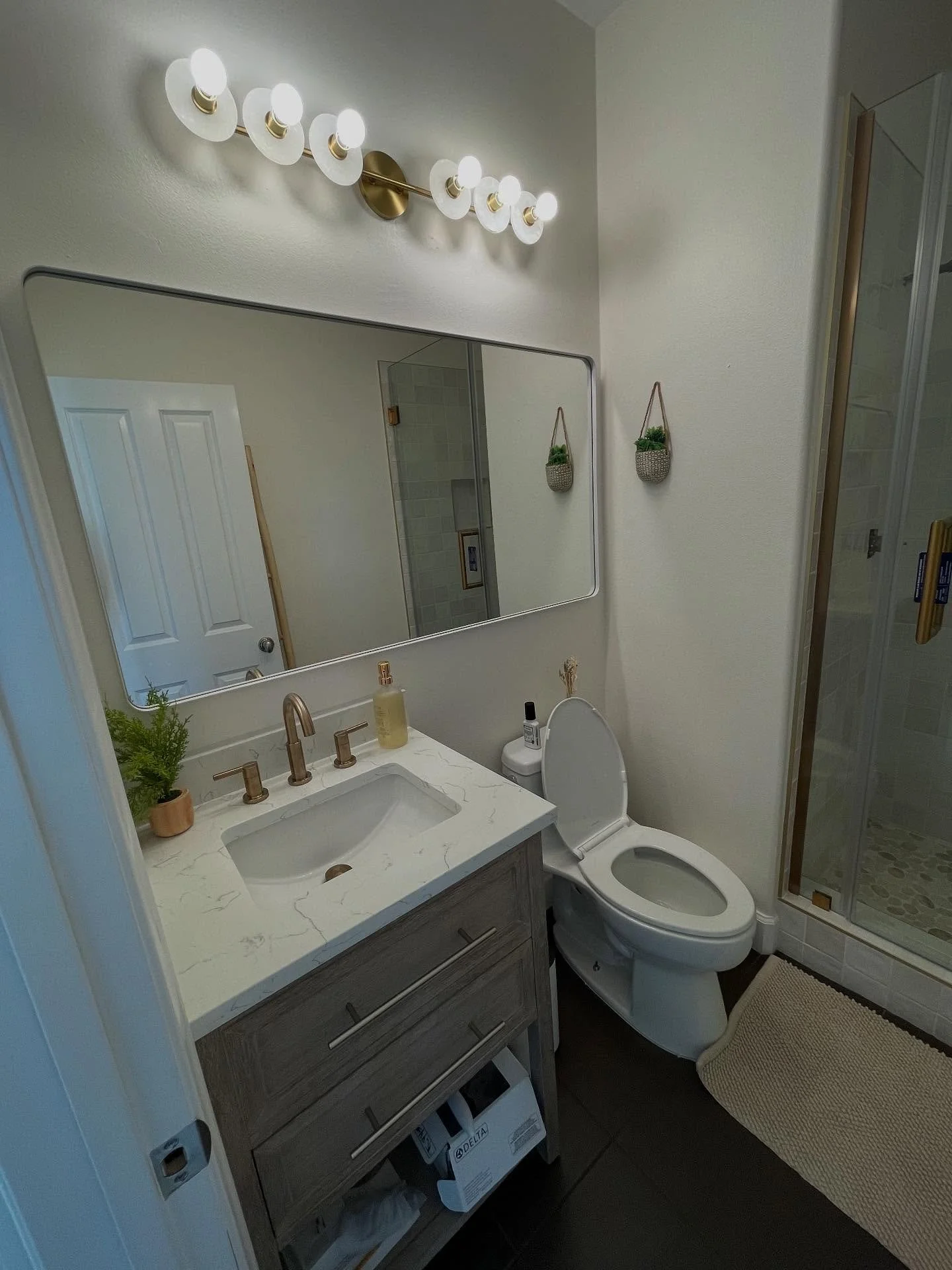 A modern take on timeless design — white oak cabinets, bronze hardware, and a squared subway-tiled walk-in shower bring character and sophistication to this bathroom remodel.
#BathroomRemodel #LuxuryBathrooms #ModernDesign #CustomCabinetry #Wh