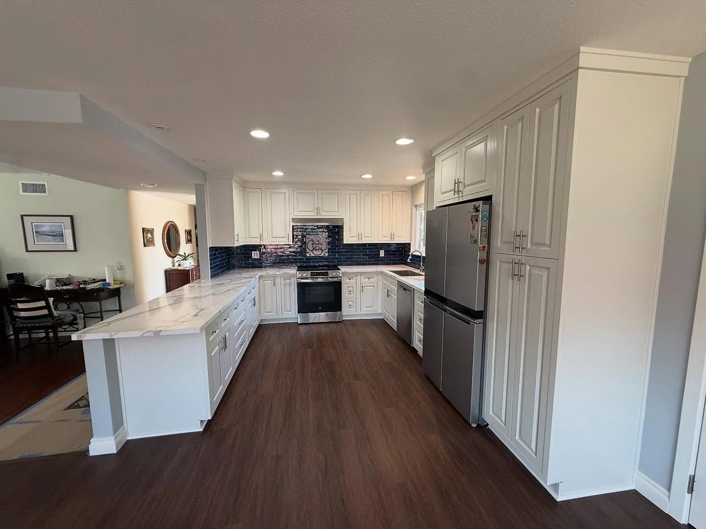 ✨ Fresh, bright, and timeless. White shaker + new tops + new floors = dream kitchen upgrade.
	•	The heart of the home just got a glow-up 🤍🍴 #KitchenRemodel
	•	Clean lines, fresh floors, and countertops that shine. Loving this transformati