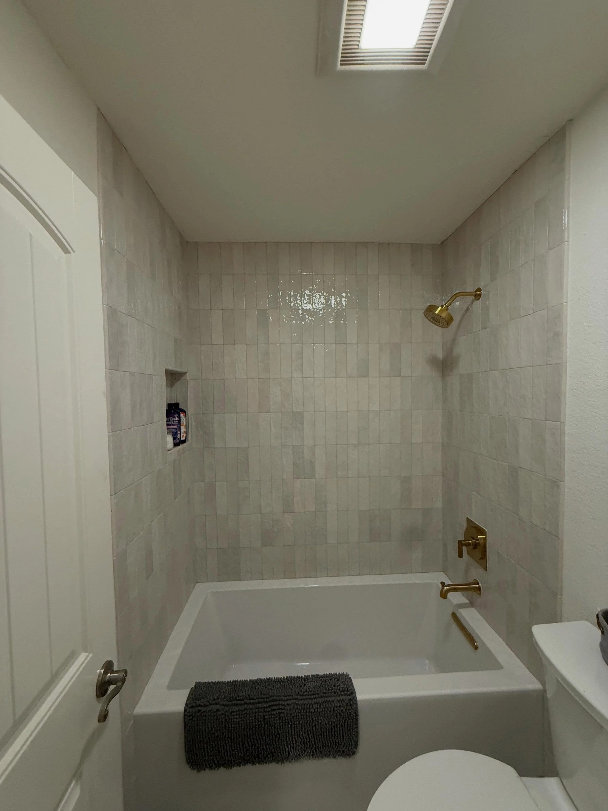 We paired vertical pearl subway tile with gold accents for a warm, stylish look that feels fresh and timeless. Another bathroom makeover in the books!

#BathroomRemodel #SubwayTile #GoldAccents #BathroomInspo #HomeRenovation