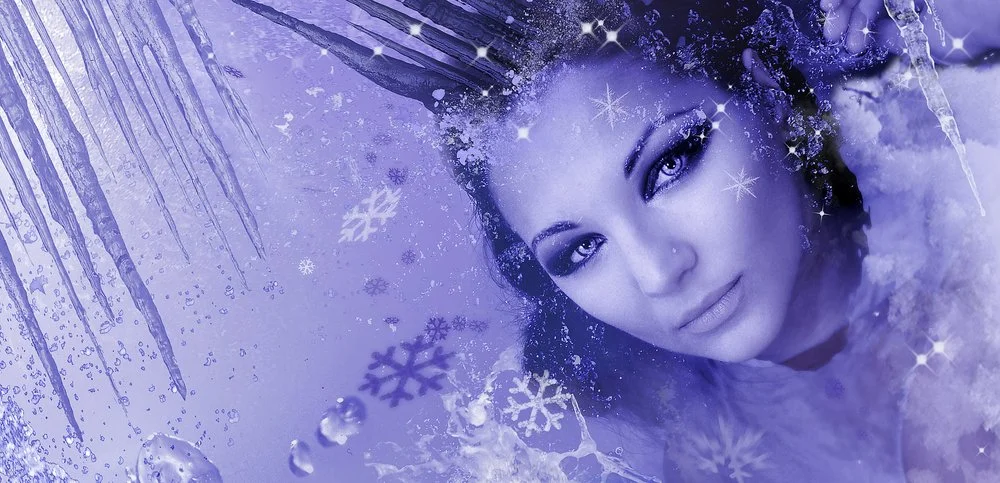 A woman with icy makeup and icy surroundings, including snowflakes and frost, presenting a winter or cold theme.