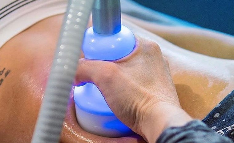 Person receiving ultrasound therapy on their abdomen.