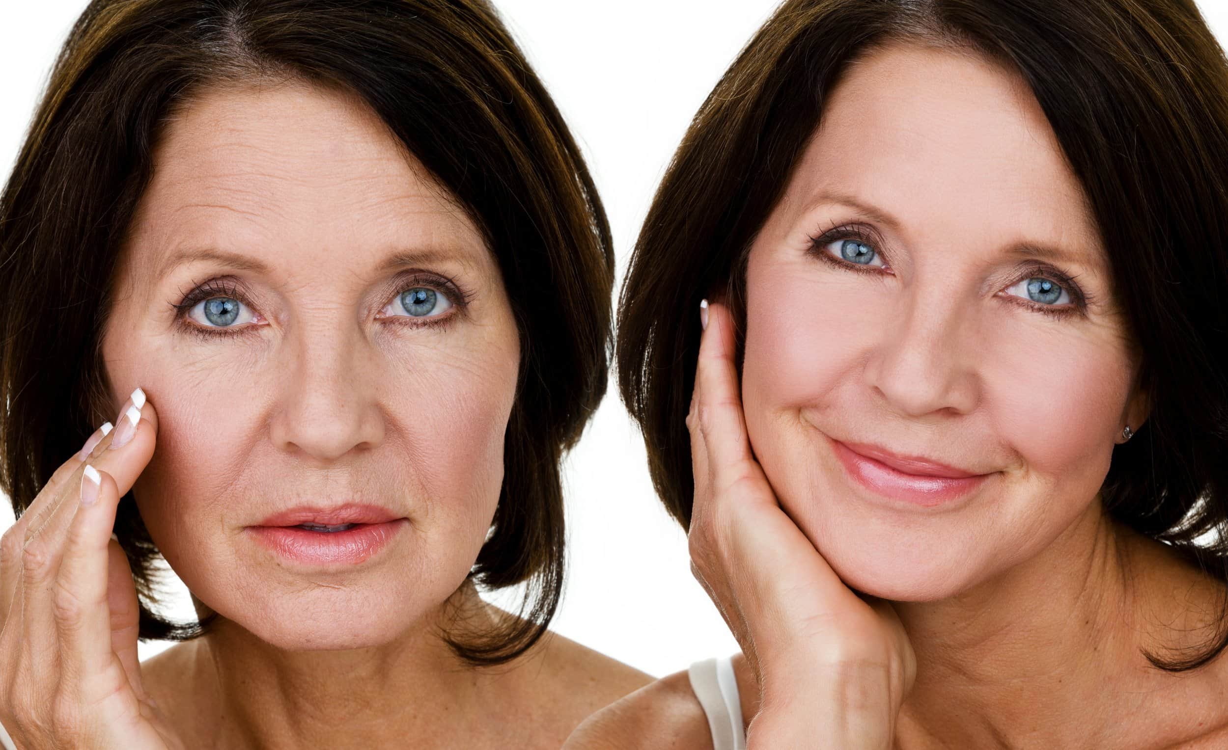 Close-up of two middle-aged women with blue eyes, dark brown hair, and light makeup, touching their faces gently, smiling and looking at the camera.